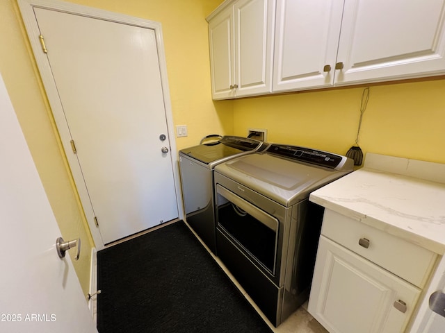 washroom featuring cabinets and washer and dryer