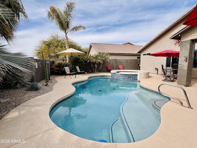 view of swimming pool with an in ground hot tub and a patio