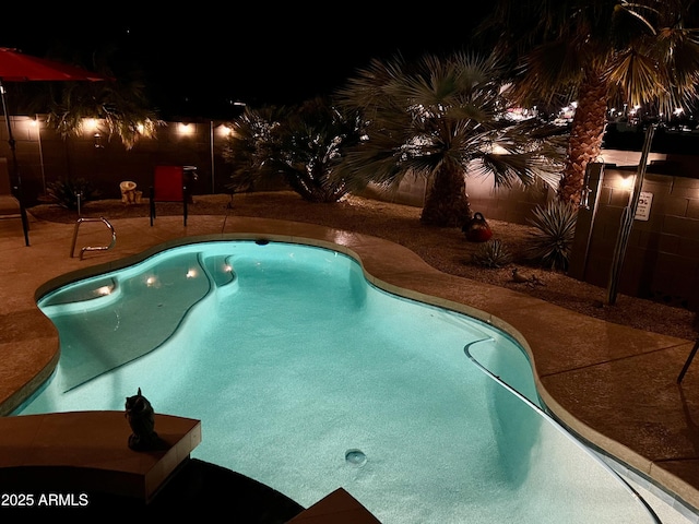 pool at night with a patio