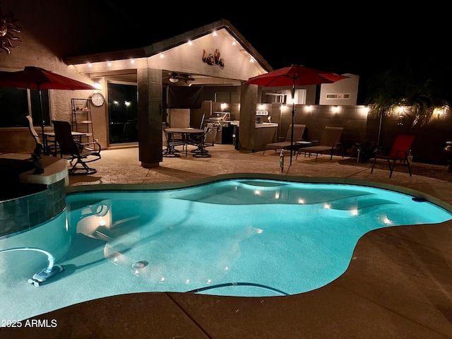 view of pool with a patio area, ceiling fan, and an outdoor kitchen