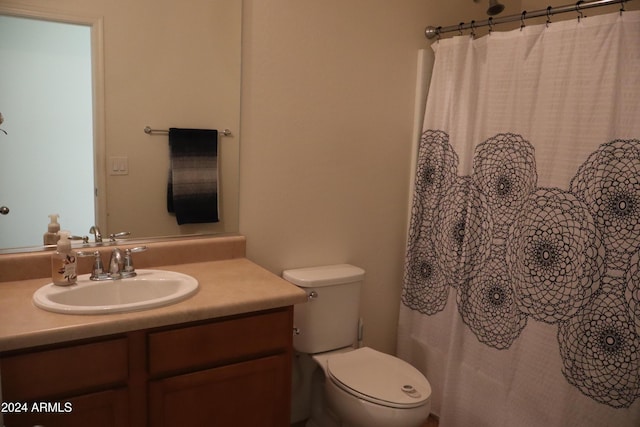 bathroom with vanity, a shower with shower curtain, and toilet