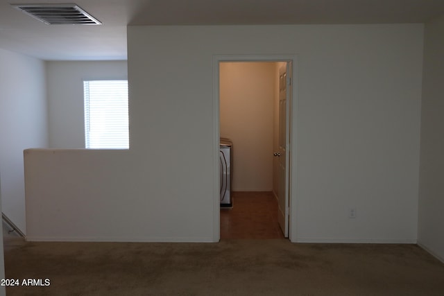 carpeted spare room with washer / clothes dryer