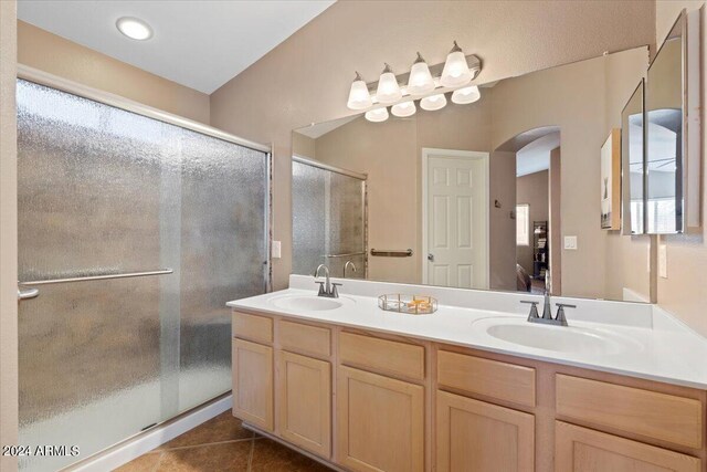 bathroom with vanity, walk in shower, and tile patterned flooring