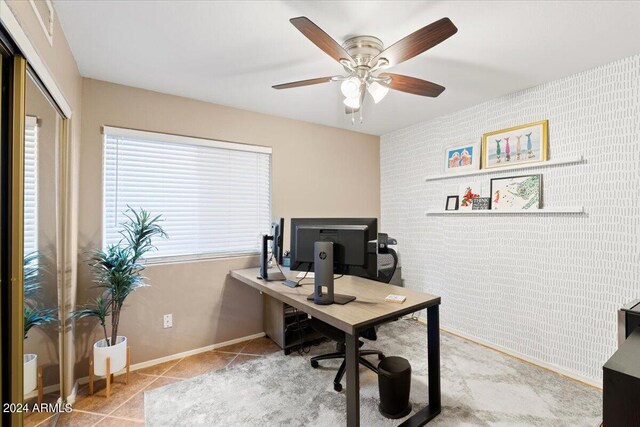 office space with light tile patterned floors and ceiling fan