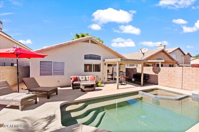 view of pool featuring an in ground hot tub, a patio area, and outdoor lounge area