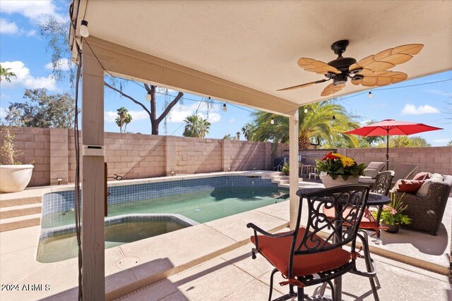 view of swimming pool featuring a patio and ceiling fan