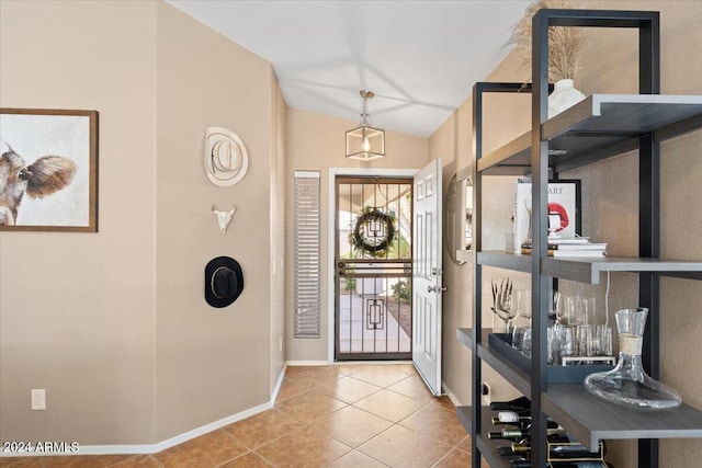 tiled entryway featuring vaulted ceiling