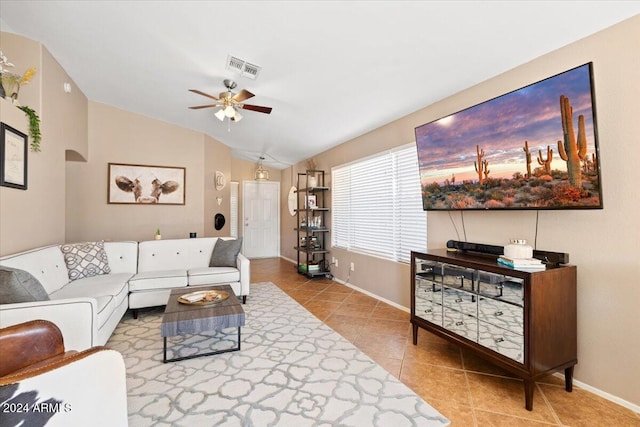 tiled living room featuring lofted ceiling and ceiling fan