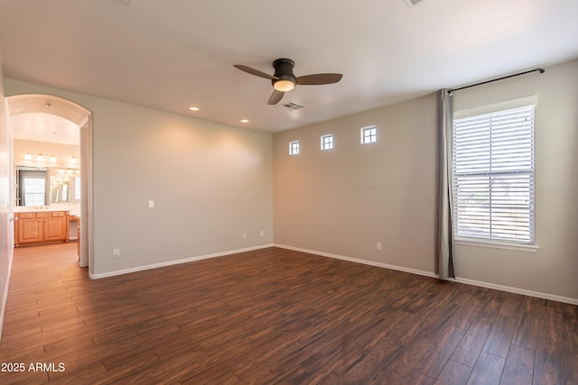 18283 N 93rd St, Scottsdale, AZ 85255 - spare room featuring a ceiling fan, wood finished floors, arched walkways, baseboards, and recessed lighting