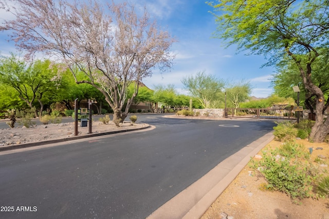 18283 N 93rd St, Scottsdale, AZ 85255 - view of asphalt road featuring curbs and a gated entry