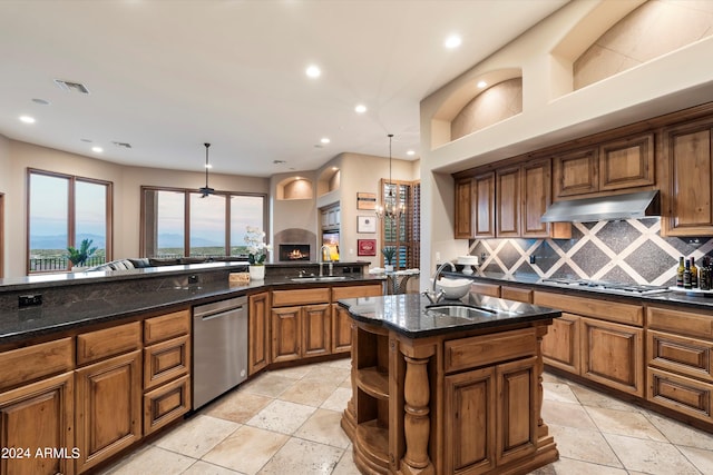 kitchen featuring sink, an island with sink, appliances with stainless steel finishes, and tasteful backsplash