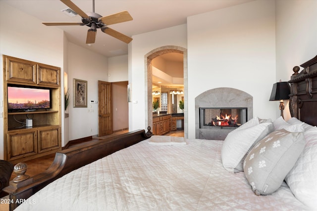 bedroom with ensuite bathroom and ceiling fan