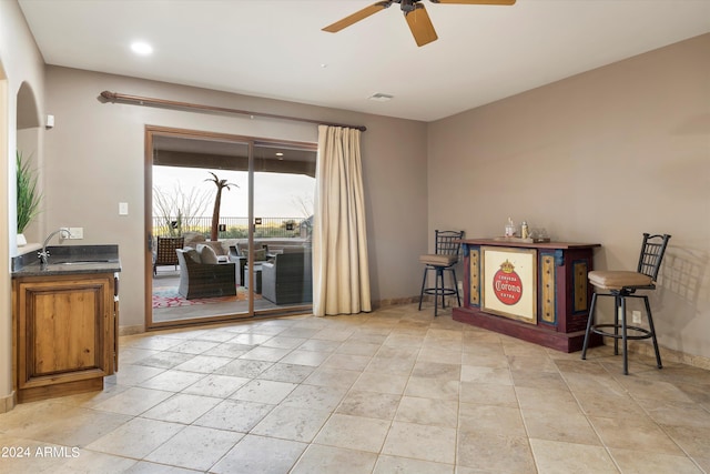 interior space with ceiling fan and sink