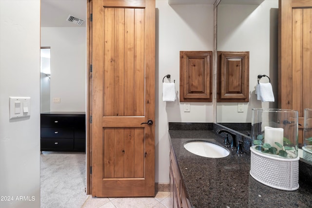 bathroom featuring tile patterned flooring and vanity