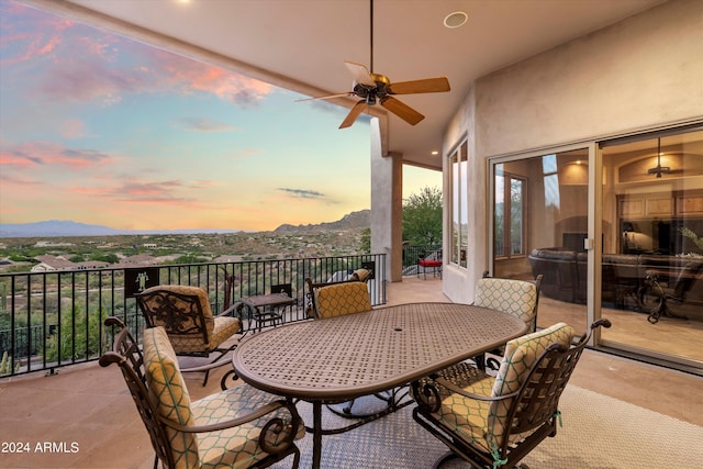 view of patio / terrace featuring a mountain view, exterior fireplace, and ceiling fan