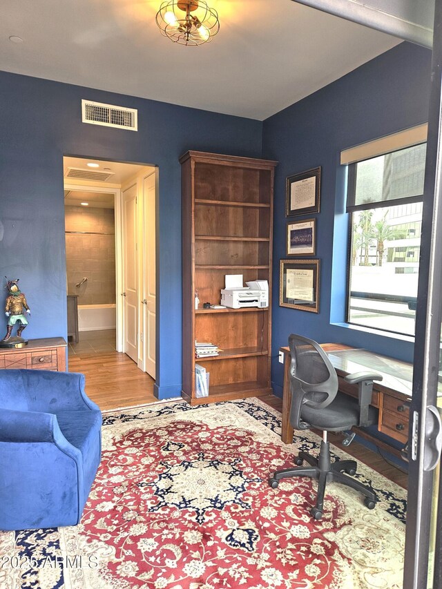 office space with wood finished floors and visible vents