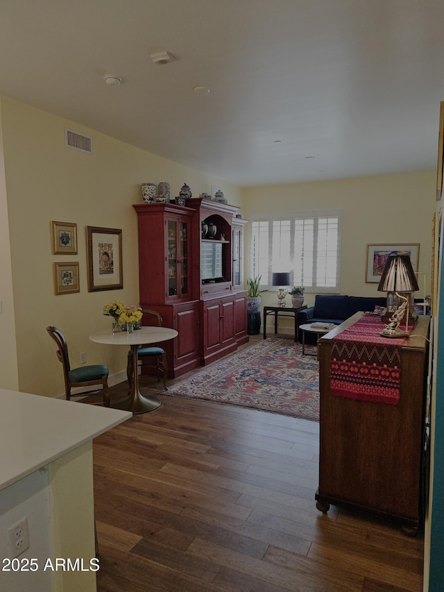 living room featuring visible vents and dark wood-style floors