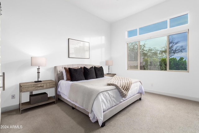 carpeted bedroom with vaulted ceiling