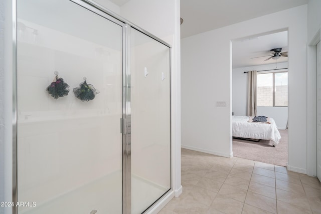 bathroom featuring ceiling fan, tile patterned floors, and an enclosed shower