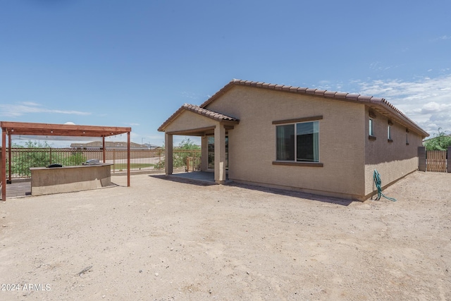 back of property with a patio