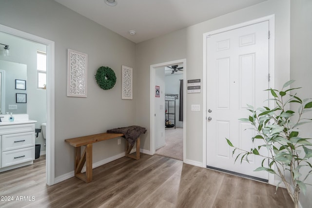 foyer with ceiling fan and light hardwood / wood-style flooring