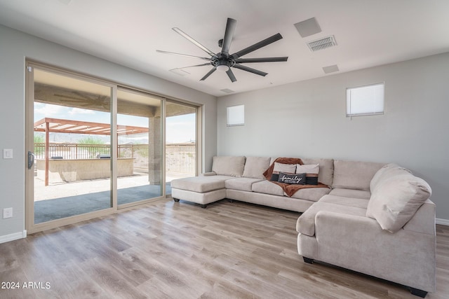 living room featuring ceiling fan and light hardwood / wood-style floors