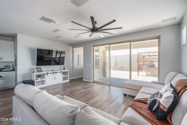 living room with ceiling fan and light hardwood / wood-style floors