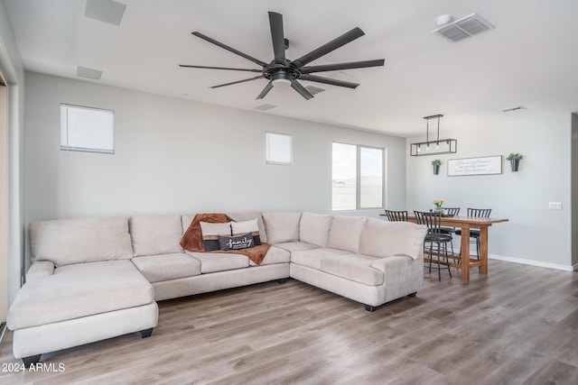 living room featuring ceiling fan and light hardwood / wood-style flooring