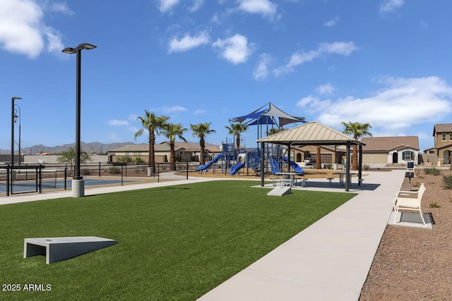 view of play area with a mountain view, a gazebo, and a lawn