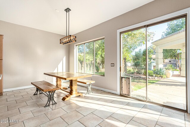 unfurnished dining area featuring light tile patterned flooring