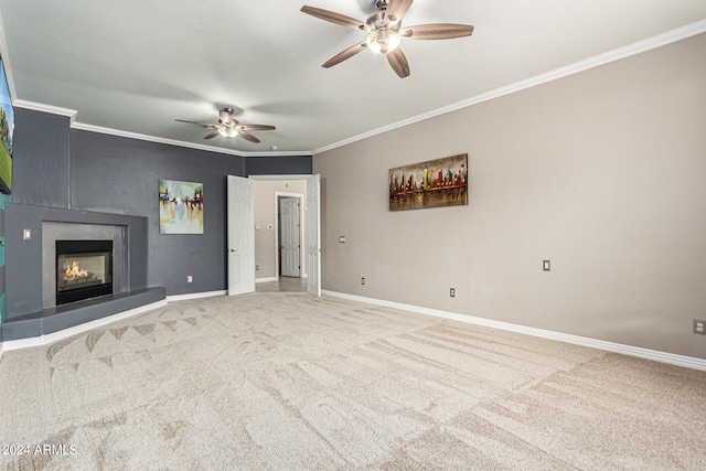 unfurnished living room with carpet, ornamental molding, and ceiling fan