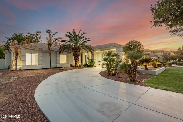 mediterranean / spanish-style house with a lawn