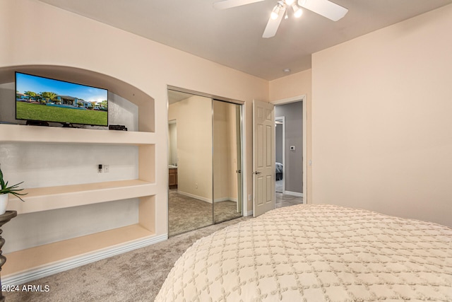 carpeted bedroom featuring ceiling fan and a closet