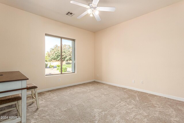 interior space featuring ceiling fan and light colored carpet