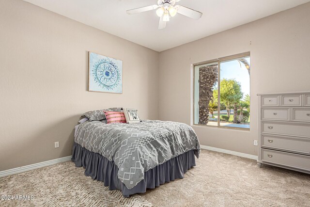 bedroom with ceiling fan and carpet floors