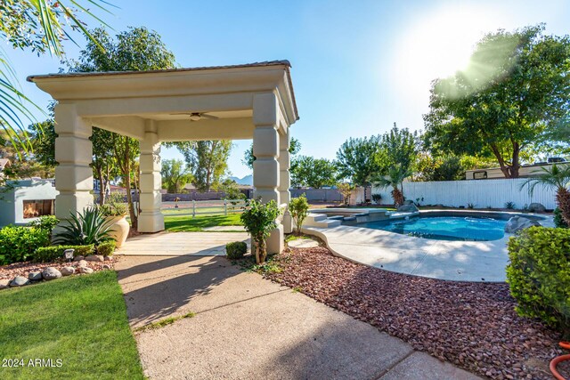 view of pool with a patio and ceiling fan