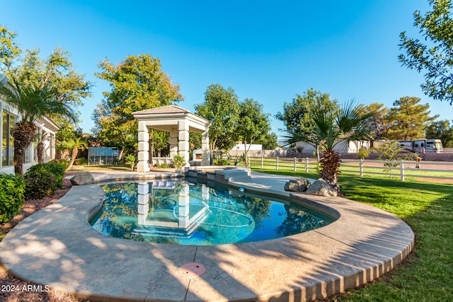 view of pool featuring a lawn