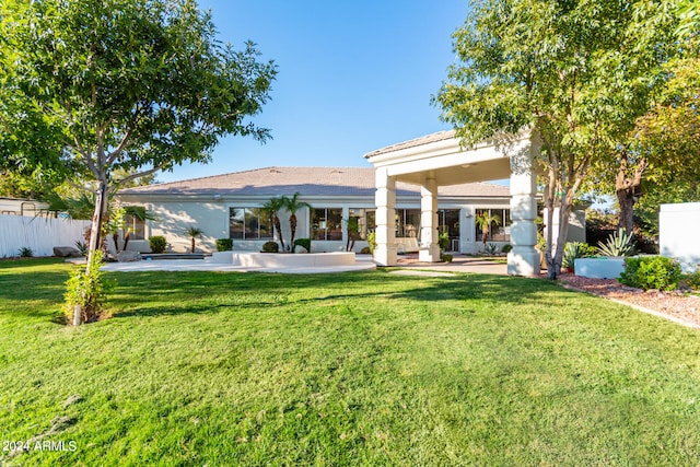 rear view of property with a lawn