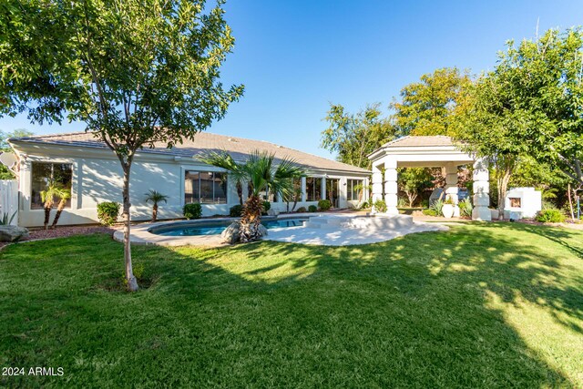 back of house with a yard and a patio area