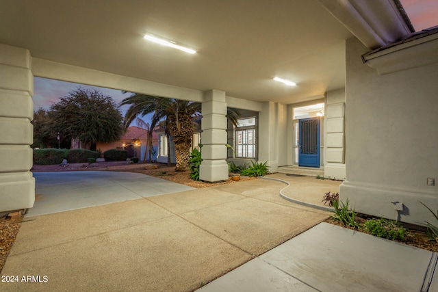 exterior entry at dusk featuring a patio