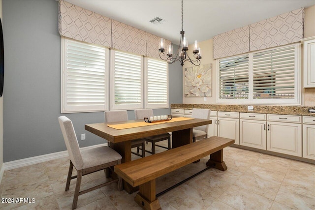 dining area featuring a notable chandelier