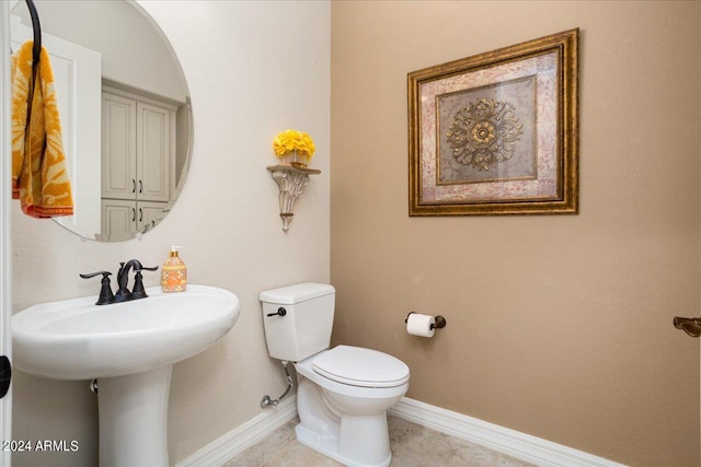 bathroom featuring sink, toilet, and tile patterned floors