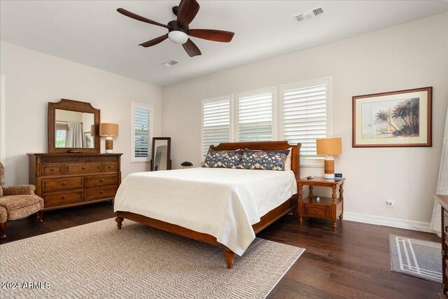 bedroom with ceiling fan and dark wood-type flooring