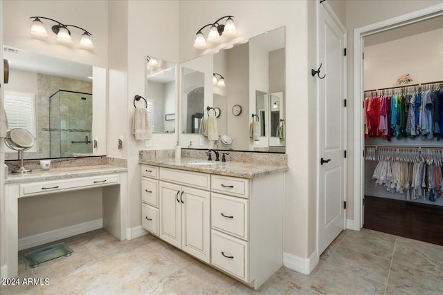 bathroom with walk in shower and vanity