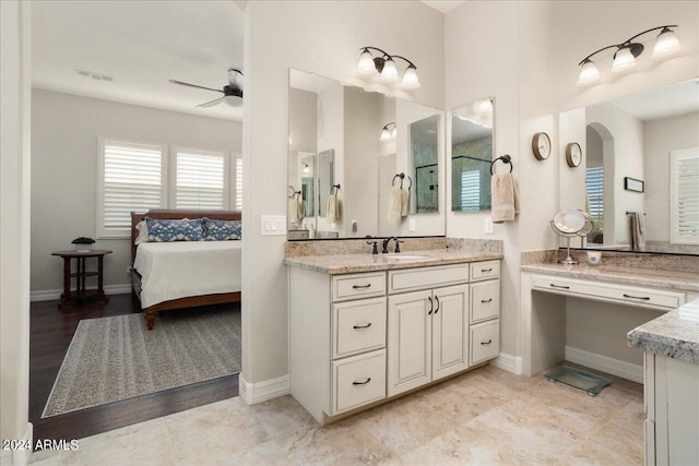 bathroom featuring hardwood / wood-style floors, ceiling fan, and vanity