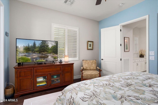 bedroom featuring dark wood-type flooring, ensuite bath, and ceiling fan