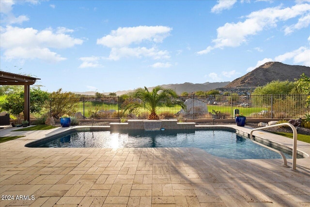 view of swimming pool with a patio, a mountain view, and pool water feature