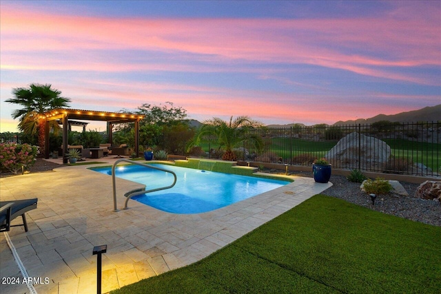 pool at dusk with a patio and a yard