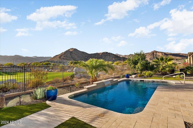 view of pool with a patio area and a mountain view