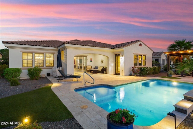 back house at dusk with a patio